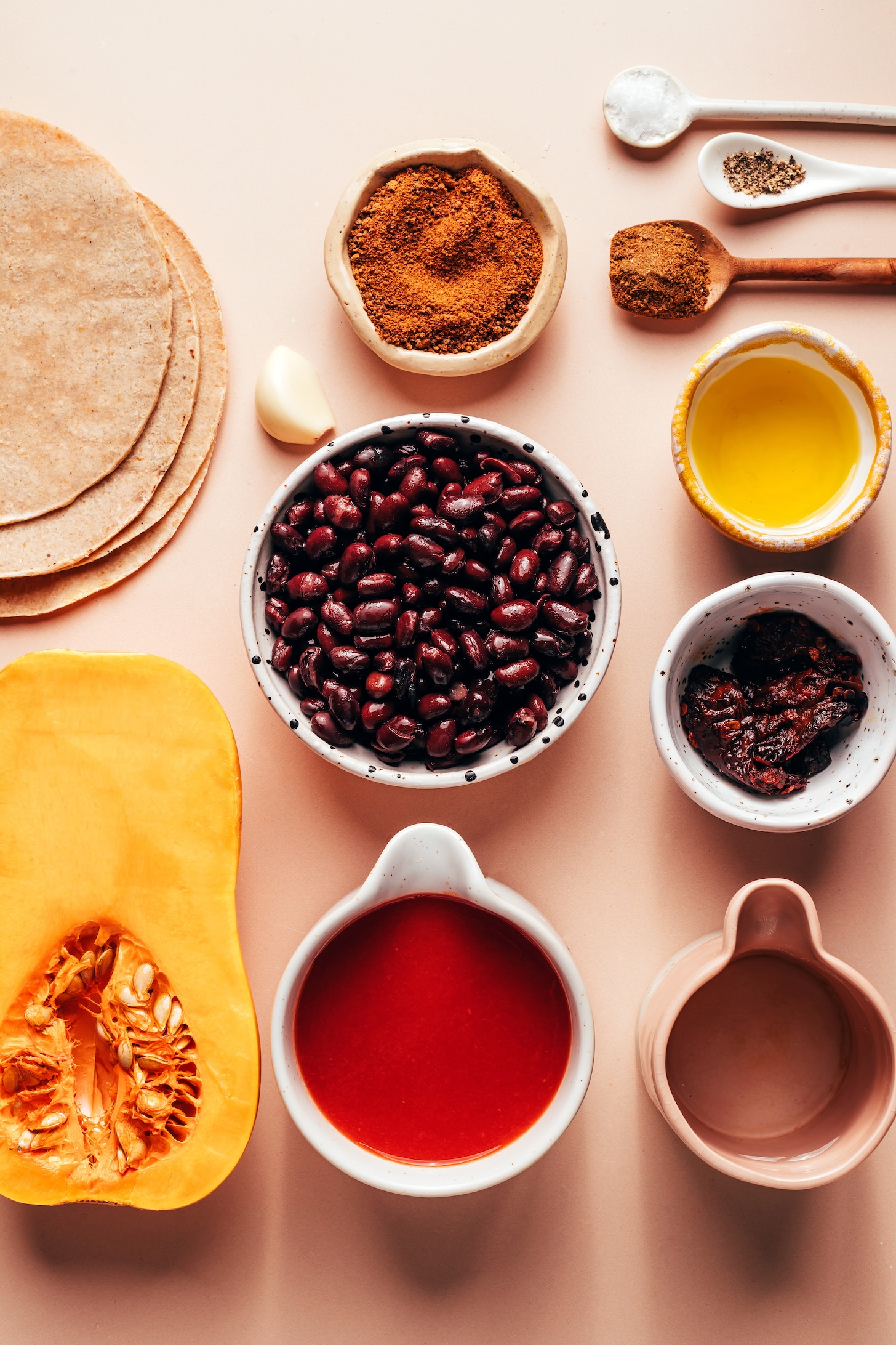 Corn tortillas, butternut squash, tomato sauce, water, chipotle peppers in adobo, black beans, oil, cumin, black pepper, salt, garlic, and coconut sugar